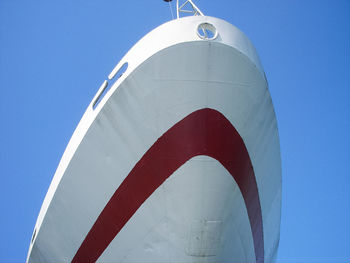 Low angle view of airplane against clear blue sky