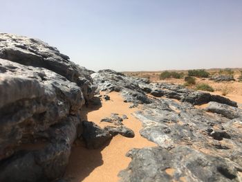 Rock formations on land against clear sky