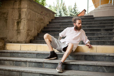 Young man sitting on steps