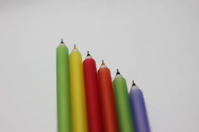 Close-up of colored pencils against white background