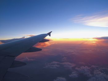 Cropped image of airplane wing over landscape