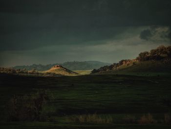 Scenic view of landscape against cloudy sky