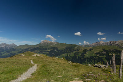 Scenic view of mountains against blue sky