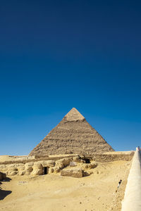 Low angle view of historical building against clear blue sky