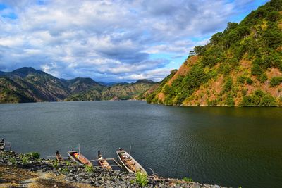 Scenic view of lake and mountains against sky