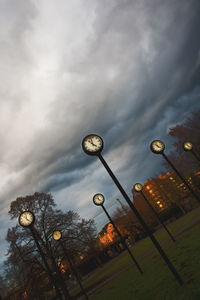 Low angle view of street light against cloudy sky