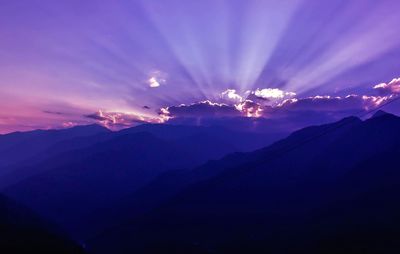 Scenic view of mountains against sky at sunset