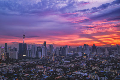 High angle view of buildings against cloudy sky at sunset