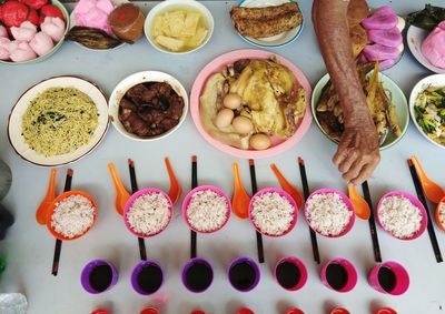 Cropped hand of woman having food at table