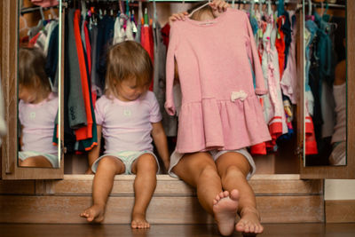 Rear view of women standing at home