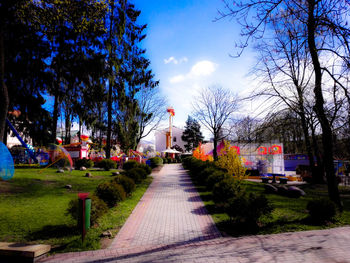 View of footpath against cloudy sky