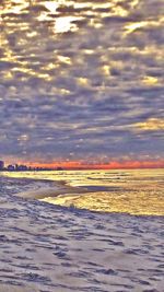 Scenic view of beach against sky during sunset