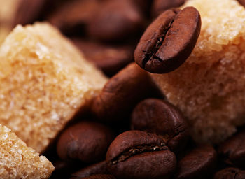 Detail shot of sugar cubes on coffee beans