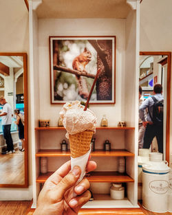 Woman holding ice cream in kitchen