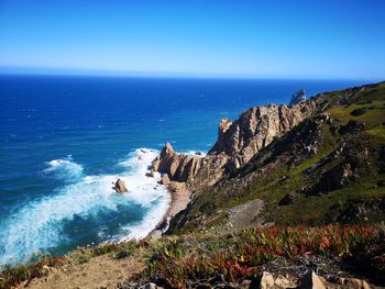 High angle view of sea against clear blue sky