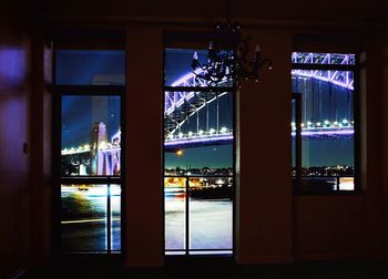 Illuminated city seen through glass window