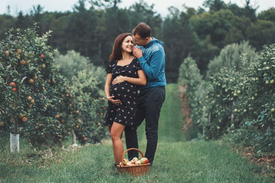 Full length of couple on field