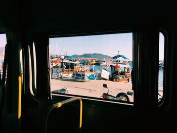 Buildings against sky seen through glass window