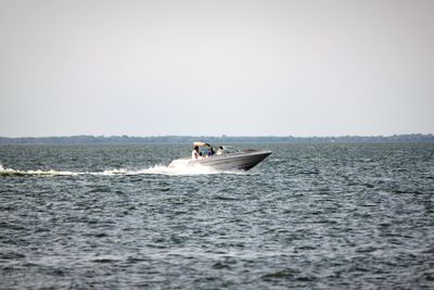 Young woman in sea against clear sky