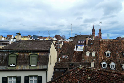 Buildings in city against cloudy sky