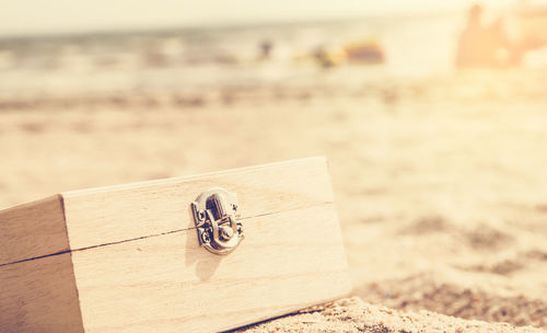 Close-up of wooden jewelry box at beach