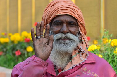 Close-up portrait of man with flowers