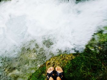 Low section of woman over river