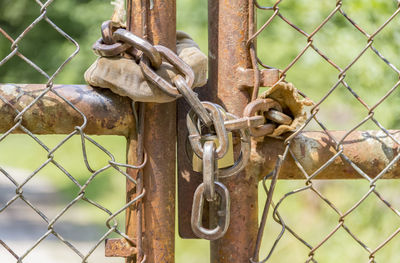 Close-up of padlock on metal fence