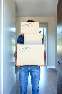 Midsection of man holding woman standing in corridor