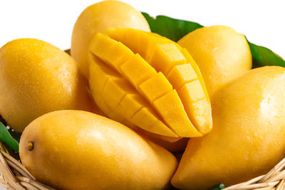 High angle view of mangoes in basket against white background