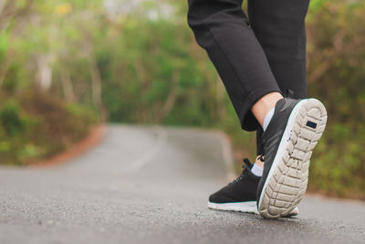 Low section of man walking on footpath