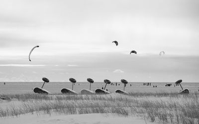 Wheels of beach sailing cars at beach against shore and sky