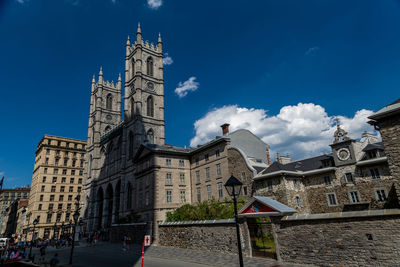 Low angle view of buildings against blue sky