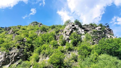 Low angle view of mountain against cloudy sky