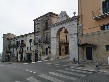 Street amidst buildings against sky in city