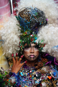 Portrait of woman wearing face paint and costume at event