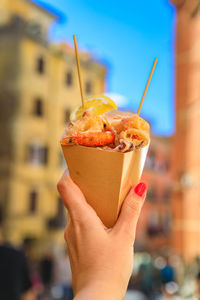 Close-up of hand holding ice cream cone