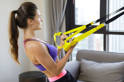 Young woman exercising in gym