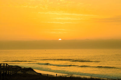 Scenic view of sea against romantic sky at sunset