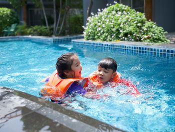 Boys swimming in pool