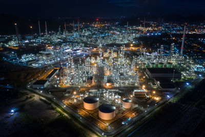 High angle view refinery of illuminated city at night