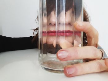 Close-up of hand holding glass of juice