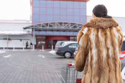 Rear view of woman standing in city