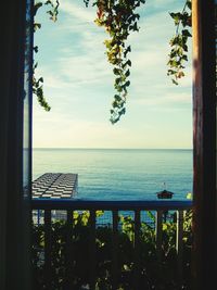Scenic view of sea against sky seen through window