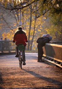 Full length of woman standing on tree trunk