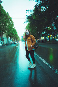 Man walking on road in city