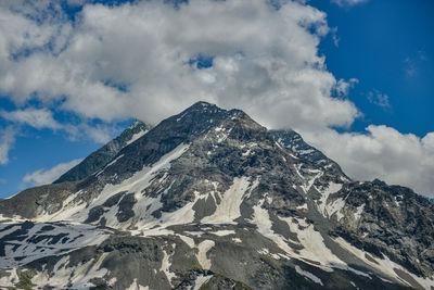 Low angle view of snowcapped mountains against sky