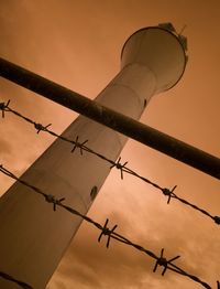 Low angle view of tower against sky during sunset