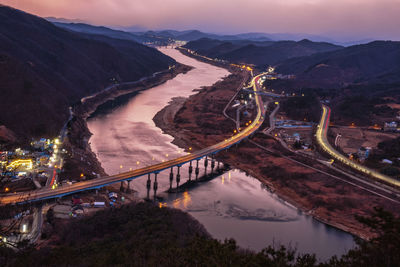 High angle view of illuminated bridge over river in city