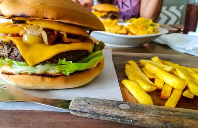 Burger with french fries on table